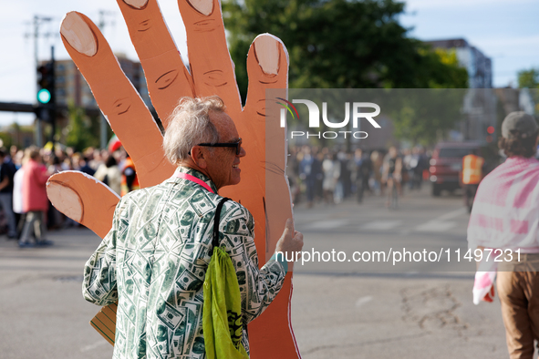 A demonstrator carries a prop near an entrance to the Democratic National Convention in Chicago, Illinois on August 20, 2024. 