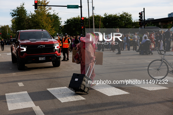 A demonstrator crosses a street near an entrance to the Democratic National Convention in Chicago, Illinois on August 20, 2024. 