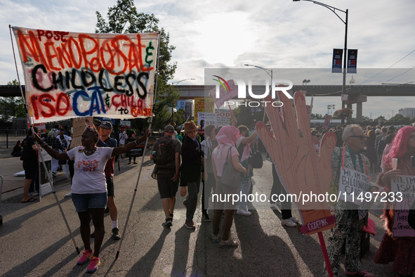 Nadine Seiler, left, holds a sign as they protest near an entrance to the Democratic National Convention in Chicago, Illinois on August 20,...