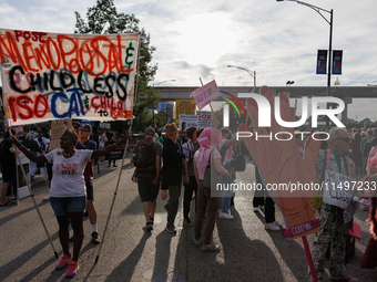 Nadine Seiler, left, holds a sign as they protest near an entrance to the Democratic National Convention in Chicago, Illinois on August 20,...