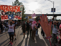 Nadine Seiler, left, holds a sign as they protest near an entrance to the Democratic National Convention in Chicago, Illinois on August 20,...