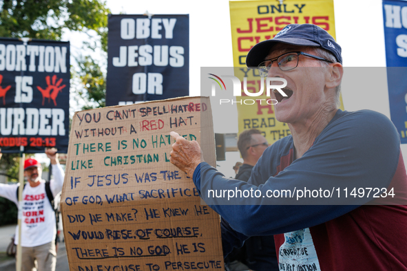 Opposing abortion rights demonstrators protest at an entrance to the Democratic National Convention in Chicago, Illinois on August 20, 2024....