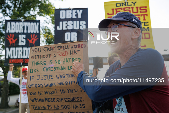 Opposing abortion rights demonstrators protest at an entrance to the Democratic National Convention in Chicago, Illinois on August 20, 2024....