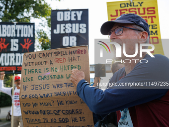 Opposing abortion rights demonstrators protest at an entrance to the Democratic National Convention in Chicago, Illinois on August 20, 2024....