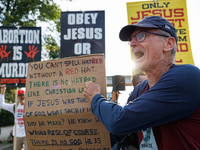 Opposing abortion rights demonstrators protest at an entrance to the Democratic National Convention in Chicago, Illinois on August 20, 2024....