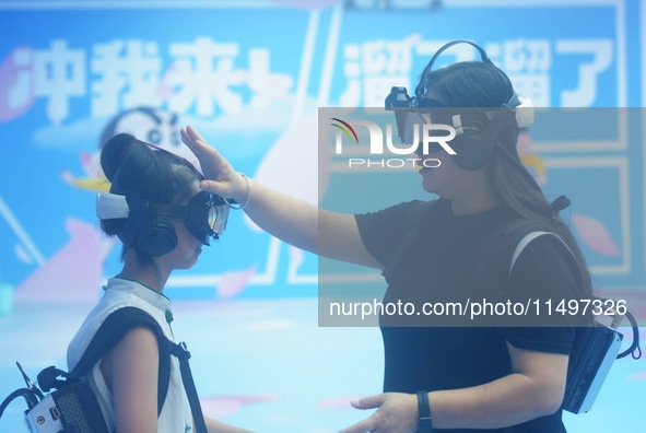 Visitors are watching the world's first VR movie ''Me and Crayon Shin-chan'' through multimedia smart VR glasses in Hangzhou, China, on Augu...