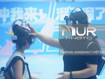 Visitors are watching the world's first VR movie ''Me and Crayon Shin-chan'' through multimedia smart VR glasses in Hangzhou, China, on Augu...