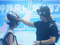 Visitors are watching the world's first VR movie ''Me and Crayon Shin-chan'' through multimedia smart VR glasses in Hangzhou, China, on Augu...