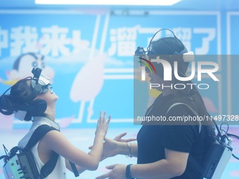 Visitors are watching the world's first VR movie ''Me and Crayon Shin-chan'' through multimedia smart VR glasses in Hangzhou, China, on Augu...