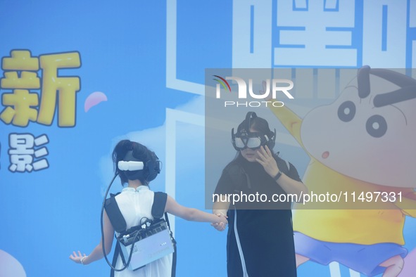 Visitors are watching the world's first VR movie ''Me and Crayon Shin-chan'' through multimedia smart VR glasses in Hangzhou, China, on Augu...