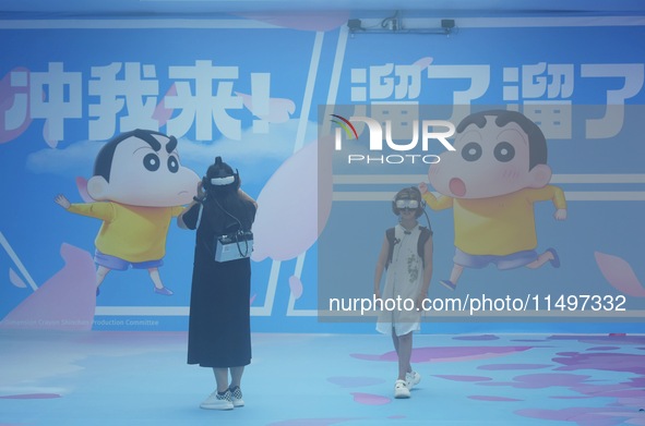 Visitors are watching the world's first VR movie ''Me and Crayon Shin-chan'' through multimedia smart VR glasses in Hangzhou, China, on Augu...