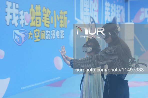 Visitors are watching the world's first VR movie ''Me and Crayon Shin-chan'' through multimedia smart VR glasses in Hangzhou, China, on Augu...