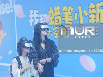 Visitors are watching the world's first VR movie ''Me and Crayon Shin-chan'' through multimedia smart VR glasses in Hangzhou, China, on Augu...