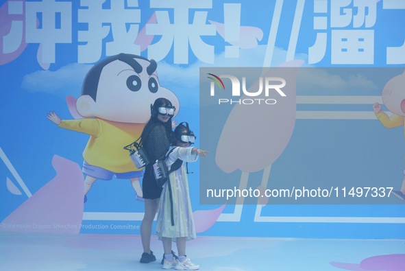 Visitors are watching the world's first VR movie ''Me and Crayon Shin-chan'' through multimedia smart VR glasses in Hangzhou, China, on Augu...