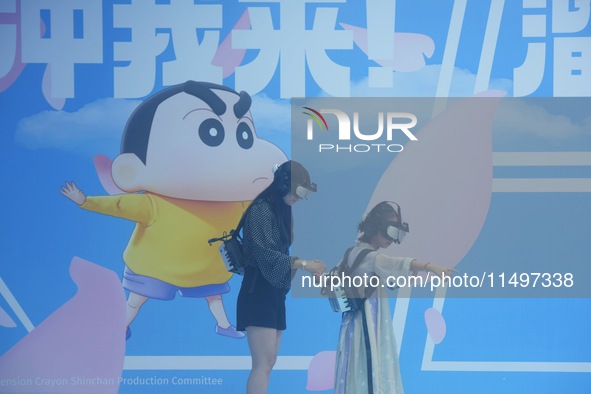 Visitors are watching the world's first VR movie ''Me and Crayon Shin-chan'' through multimedia smart VR glasses in Hangzhou, China, on Augu...