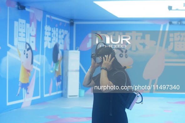 Visitors are watching the world's first VR movie ''Me and Crayon Shin-chan'' through multimedia smart VR glasses in Hangzhou, China, on Augu...