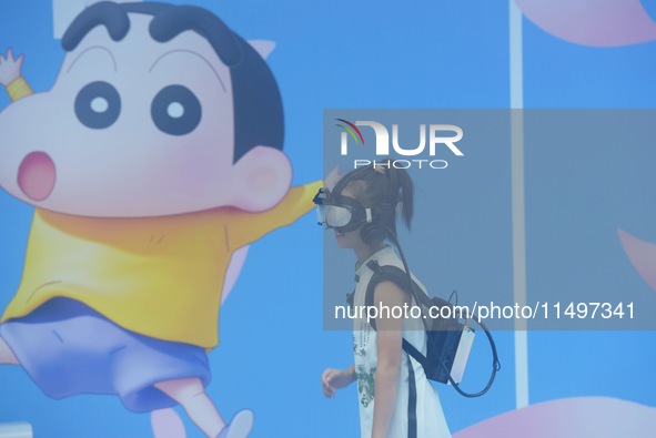 Visitors are watching the world's first VR movie ''Me and Crayon Shin-chan'' through multimedia smart VR glasses in Hangzhou, China, on Augu...