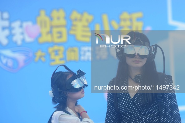 Visitors are watching the world's first VR movie ''Me and Crayon Shin-chan'' through multimedia smart VR glasses in Hangzhou, China, on Augu...