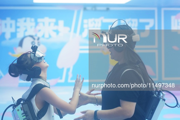 Visitors are watching the world's first VR movie ''Me and Crayon Shin-chan'' through multimedia smart VR glasses in Hangzhou, China, on Augu...