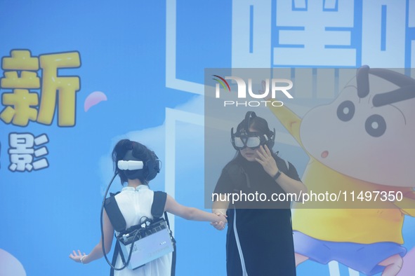 Visitors are watching the world's first VR movie ''Me and Crayon Shin-chan'' through multimedia smart VR glasses in Hangzhou, China, on Augu...