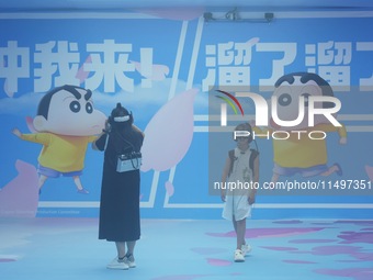 Visitors are watching the world's first VR movie ''Me and Crayon Shin-chan'' through multimedia smart VR glasses in Hangzhou, China, on Augu...