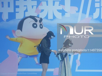 Visitors are watching the world's first VR movie ''Me and Crayon Shin-chan'' through multimedia smart VR glasses in Hangzhou, China, on Augu...