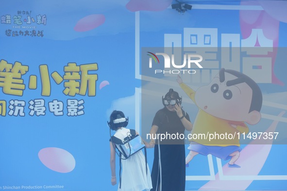 Visitors are watching the world's first VR movie ''Me and Crayon Shin-chan'' through multimedia smart VR glasses in Hangzhou, China, on Augu...