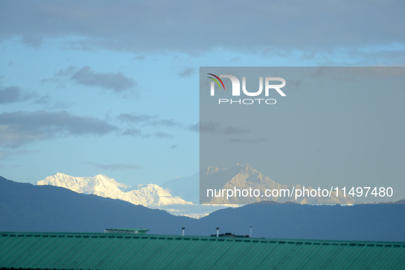 The peak of Mount Kanchenjunga in the eastern Himalayan range, the third highest mountain in the world, is seen from Siliguri, India, on Aug...