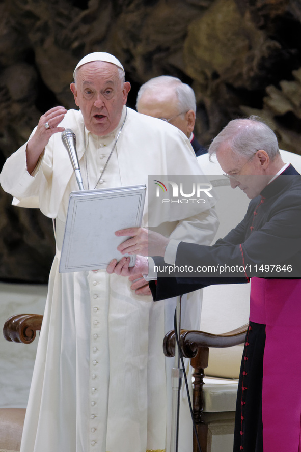 Pope Francis blesses the crowd during the weekly general audience at the Vatican, on August 21, 2024. 