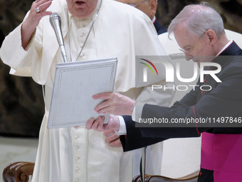 Pope Francis blesses the crowd during the weekly general audience at the Vatican, on August 21, 2024. (