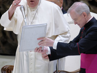 Pope Francis blesses the crowd during the weekly general audience at the Vatican, on August 21, 2024. (