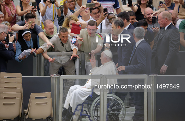 Pope Francis greets people at the end of the weekly general audience in The Vatican, on August 21, 2024, at Paul-VI hall. 