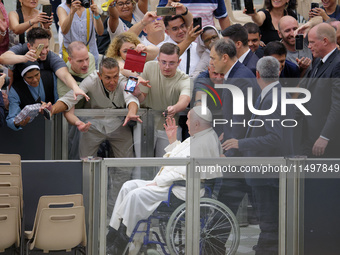 Pope Francis greets people at the end of the weekly general audience in The Vatican, on August 21, 2024, at Paul-VI hall. (