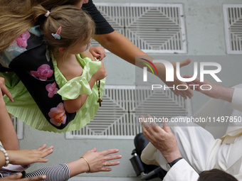 Pope Francis greets people at the end of the weekly general audience in The Vatican, on August 21, 2024, at Paul-VI hall. (