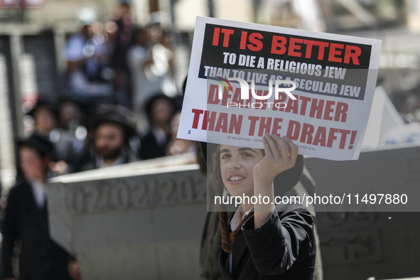 Israeli police officers intervene in Ultra-Orthodox Jews, also known as Haredim, who gather to stage a protest against mandatory military se...