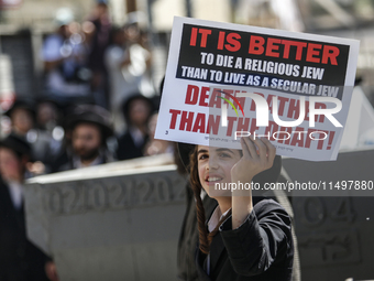 Israeli police officers intervene in Ultra-Orthodox Jews, also known as Haredim, who gather to stage a protest against mandatory military se...