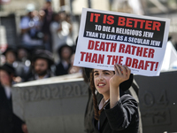 Israeli police officers intervene in Ultra-Orthodox Jews, also known as Haredim, who gather to stage a protest against mandatory military se...