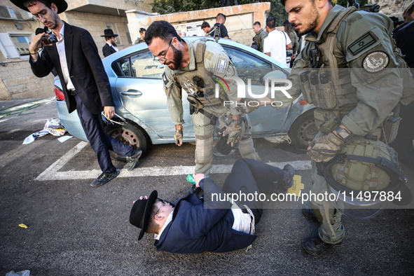 Israeli police officers intervene in Ultra-Orthodox Jews, also known as Haredim, who gather to stage a protest against mandatory military se...