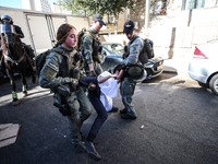 Israeli police officers intervene in Ultra-Orthodox Jews, also known as Haredim, who gather to stage a protest against mandatory military se...