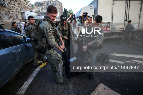 Israeli police officers intervene in Ultra-Orthodox Jews, also known as Haredim, who gather to stage a protest against mandatory military se...