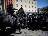 Israeli police officers intervene in Ultra-Orthodox Jews, also known as Haredim, who gather to stage a protest against mandatory military se...