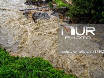 Bagmati River floods and affects riverbanks during heavy rainfall in Kathmandu, Nepal, on August 21, 2024 (