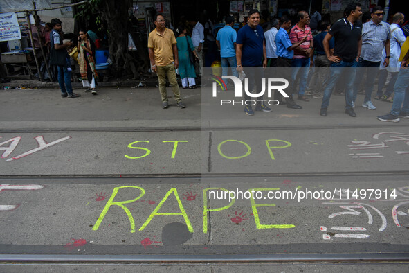 ''Stop rape'' is written on the road by protesters as the protest against the rape of a junior doctor enters the 12th day, as seen in Kolkat...