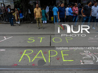 ''Stop rape'' is written on the road by protesters as the protest against the rape of a junior doctor enters the 12th day, as seen in Kolkat...