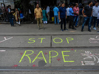 ''Stop rape'' is written on the road by protesters as the protest against the rape of a junior doctor enters the 12th day, as seen in Kolkat...