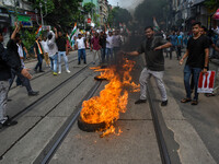 Supporters of the Congress party burn a tire in protest against the rape and murder of a junior doctor in Kolkata, India, on August 21, 2024...