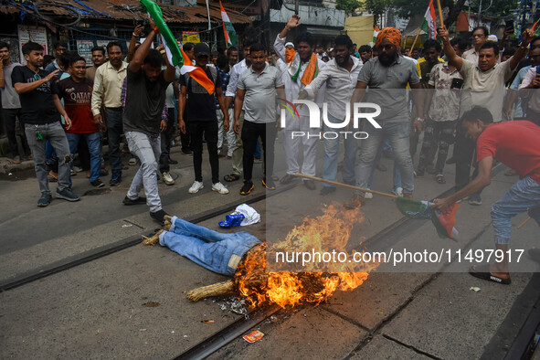 Supporters of the Congress party burn an effigy in protest against the rape and murder of a junior doctor in Kolkata, India, on August 21, 2...