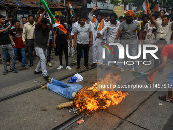 Supporters of the Congress party burn an effigy in protest against the rape and murder of a junior doctor in Kolkata, India, on August 21, 2...