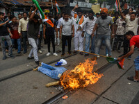 Supporters of the Congress party burn an effigy in protest against the rape and murder of a junior doctor in Kolkata, India, on August 21, 2...