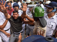 Police arrest supporters of the Indian National Congress during a protest against the rape and murder of a junior doctor in Kolkata, India,...